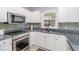 Modern kitchen featuring stainless steel appliances, granite countertops, and stylish backsplash at 4847 Carnation Circle # 201, Myrtle Beach, SC 29577