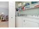 Functional laundry room with washer, dryer, and shelving for storage at 4847 Carnation Circle # 201, Myrtle Beach, SC 29577