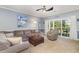 Comfortable living room with a large sectional sofa, accent chair, and sliding doors to the outside at 4847 Carnation Circle # 201, Myrtle Beach, SC 29577