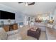 Open-concept living room with a sectional sofa, entertainment center, and view into the dining area at 4847 Carnation Circle # 201, Myrtle Beach, SC 29577