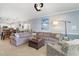 Cozy living room with a sectional sofa, accent chair, and view into the open-concept kitchen at 4847 Carnation Circle # 201, Myrtle Beach, SC 29577