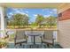 Relaxing patio featuring a table and chairs overlooking a lush golf course and lake at 4847 Carnation Circle # 201, Myrtle Beach, SC 29577