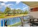 Inviting patio area with table and chairs, offering scenic views of the golf course and pond at 4847 Carnation Circle # 201, Myrtle Beach, SC 29577