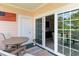 Cozy patio features a table and chairs next to a sliding door, overlooking greenery at 4847 Carnation Circle # 201, Myrtle Beach, SC 29577