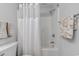 Close-up of shower-tub combo with white curtain and white-tile surround at 503 20Th Ave. N # 15-A, North Myrtle Beach, SC 29582