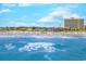 Aerial view of a beautiful beach with ocean waves and beachgoers under a sunny sky at 503 20Th Ave. N # 15-A, North Myrtle Beach, SC 29582