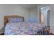 Comfortable bedroom showcases a woven headboard and floral bedding next to closet and bathroom at 503 20Th Ave. N # 15-A, North Myrtle Beach, SC 29582
