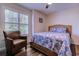 Relaxing bedroom with a wicker bed, chair, plantation shutters, and stylish wood-look flooring at 503 20Th Ave. N # 15-A, North Myrtle Beach, SC 29582
