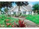 Charming white single-story house with blue shutters and lush landscaping at 503 20Th Ave. N # 15-A, North Myrtle Beach, SC 29582