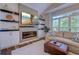 Stylish living room featuring a modern fireplace, mounted TV, and comfortable seating area near a bright window at 503 20Th Ave. N # 15-A, North Myrtle Beach, SC 29582
