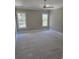Well-lit bedroom with natural paint, ceiling fan, and large windows at 507 Hillside Dr. N, North Myrtle Beach, SC 29582