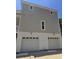 A large house with multiple garage doors underneath a two story building, freshly painted at 507 Hillside Dr. N, North Myrtle Beach, SC 29582