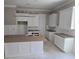 Spacious kitchen with white cabinets, center island, and modern lighting fixture at 507 Hillside Dr. N, North Myrtle Beach, SC 29582
