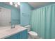 Bathroom with blue walls, featuring a toilet, vanity, and shower-tub combo at 5107 Capulet Circle, Myrtle Beach, SC 29588