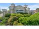Entrance to Queens Harbour with lush landscaping and well-maintained sign at 5107 Capulet Circle, Myrtle Beach, SC 29588