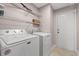 Laundry room with washer, dryer, wire shelving, and tile flooring at 5107 Capulet Circle, Myrtle Beach, SC 29588