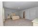 Spacious bedroom with neutral carpet, coastal decor, and an ensuite bathroom at 5309 Abbey Park Loop, Myrtle Beach, SC 29579