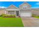 Charming two-story home with a well-manicured lawn and a two-car garage, plus inviting front porch at 5309 Abbey Park Loop, Myrtle Beach, SC 29579