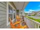 Inviting front porch with wooden rocking chairs, offering a relaxing outdoor space and neighborhood view at 5309 Abbey Park Loop, Myrtle Beach, SC 29579