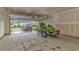 Spacious garage featuring an overhead door, with a snowmobile on a trailer and a car on the driveway at 5309 Abbey Park Loop, Myrtle Beach, SC 29579