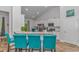 Kitchen featuring granite counters, white cabinets, breakfast bar with blue chairs, and stainless appliances at 5309 Abbey Park Loop, Myrtle Beach, SC 29579