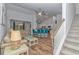 Open-concept living room and kitchen with a breakfast bar and hardwood floors at 5309 Abbey Park Loop, Myrtle Beach, SC 29579