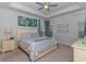Comfortable main bedroom with tray ceilings, ceiling fan, and coastal-themed artwork at 5309 Abbey Park Loop, Myrtle Beach, SC 29579