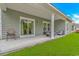 Covered patio with outdoor seating and a sliding glass door, perfect for enjoying the backyard view at 5309 Abbey Park Loop, Myrtle Beach, SC 29579