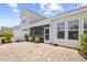 Rear exterior with patio area, small shrubs, grass, and privacy fence at 5485 Elba Way # 5485, Myrtle Beach, SC 29579