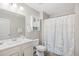 Bathroom features white cabinets, updated fixtures, decorative towel racks, and a shower with a seashell curtain at 5485 Elba Way # 5485, Myrtle Beach, SC 29579