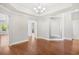 Open concept dining room with hardwood floors, bright light fixture, and an adjacent living space at 5485 Elba Way # 5485, Myrtle Beach, SC 29579