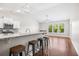 Bright, open kitchen flows into living area with granite counters, breakfast bar, and wood floors at 5485 Elba Way # 5485, Myrtle Beach, SC 29579