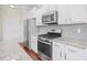 Bright kitchen with stainless steel appliances, granite counters, and white cabinetry at 5485 Elba Way # 5485, Myrtle Beach, SC 29579