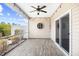 Covered patio with ceiling fan, string lights, wood flooring, and sliding door access to the home at 5485 Elba Way # 5485, Myrtle Beach, SC 29579