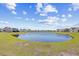 Scenic view of the community pond surrounded by lush green grass and residential homes at 5485 Elba Way # 5485, Myrtle Beach, SC 29579