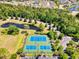 Aerial view of community tennis courts surrounded by lush landscaping and mature trees at 5485 Elba Way # 5485, Myrtle Beach, SC 29579