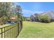Large backyard with a fire pit area, covered patio, and green lawn, great for outdoor living at 5581 Plantersville Pl., Myrtle Beach, SC 29579