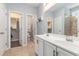 Bathroom with tile floors and a dual sink vanity with access to a walk-in closet and shower at 5581 Plantersville Pl., Myrtle Beach, SC 29579