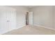 Bright bedroom with neutral walls and carpet, featuring an interior door and double door closet at 5581 Plantersville Pl., Myrtle Beach, SC 29579