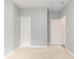 Bedroom featuring neutral colored walls and carpet with two interior doors at 5581 Plantersville Pl., Myrtle Beach, SC 29579