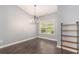Dining room features modern chandelier, shelving, and bright window at 5581 Plantersville Pl., Myrtle Beach, SC 29579