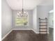 Cozy dining room boasts a modern chandelier and bright window at 5581 Plantersville Pl., Myrtle Beach, SC 29579