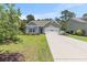 Single-Gathering home featuring a spacious driveway, lush lawn, and charming curb appeal at 5581 Plantersville Pl., Myrtle Beach, SC 29579