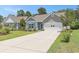 Inviting single-Gathering home featuring a long driveway, lush lawn, and charming curb appeal at 5581 Plantersville Pl., Myrtle Beach, SC 29579