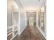 Spacious hallway featuring hardwood floors, decorative mirrors, and an archway to the living area at 5581 Plantersville Pl., Myrtle Beach, SC 29579