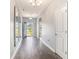 Elegant hallway features hardwood floors, decorative mirrors, and an open doorway to the outside at 5581 Plantersville Pl., Myrtle Beach, SC 29579