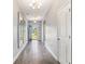 Bright hallway with hardwood floors, decorative mirrors, and an open view to the outdoors at 5581 Plantersville Pl., Myrtle Beach, SC 29579