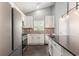 Well-lit kitchen boasts white cabinets, stainless steel appliances, and sleek countertops at 5581 Plantersville Pl., Myrtle Beach, SC 29579