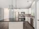 Modern kitchen features white cabinets, stainless appliances, and black countertop island at 5581 Plantersville Pl., Myrtle Beach, SC 29579