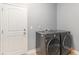 Well-equipped laundry room with gray LG washer and dryer next to a white entry door at 5581 Plantersville Pl., Myrtle Beach, SC 29579